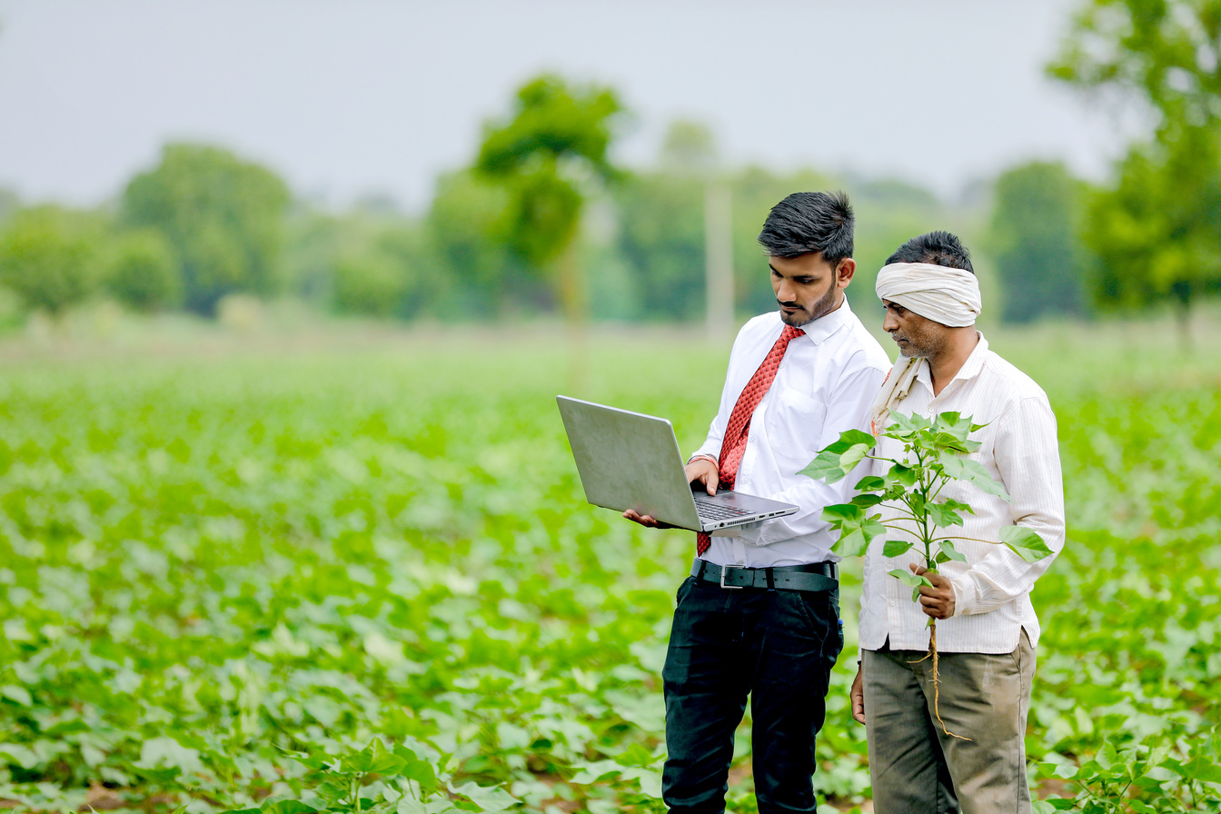 indian agronomist with farmer at field