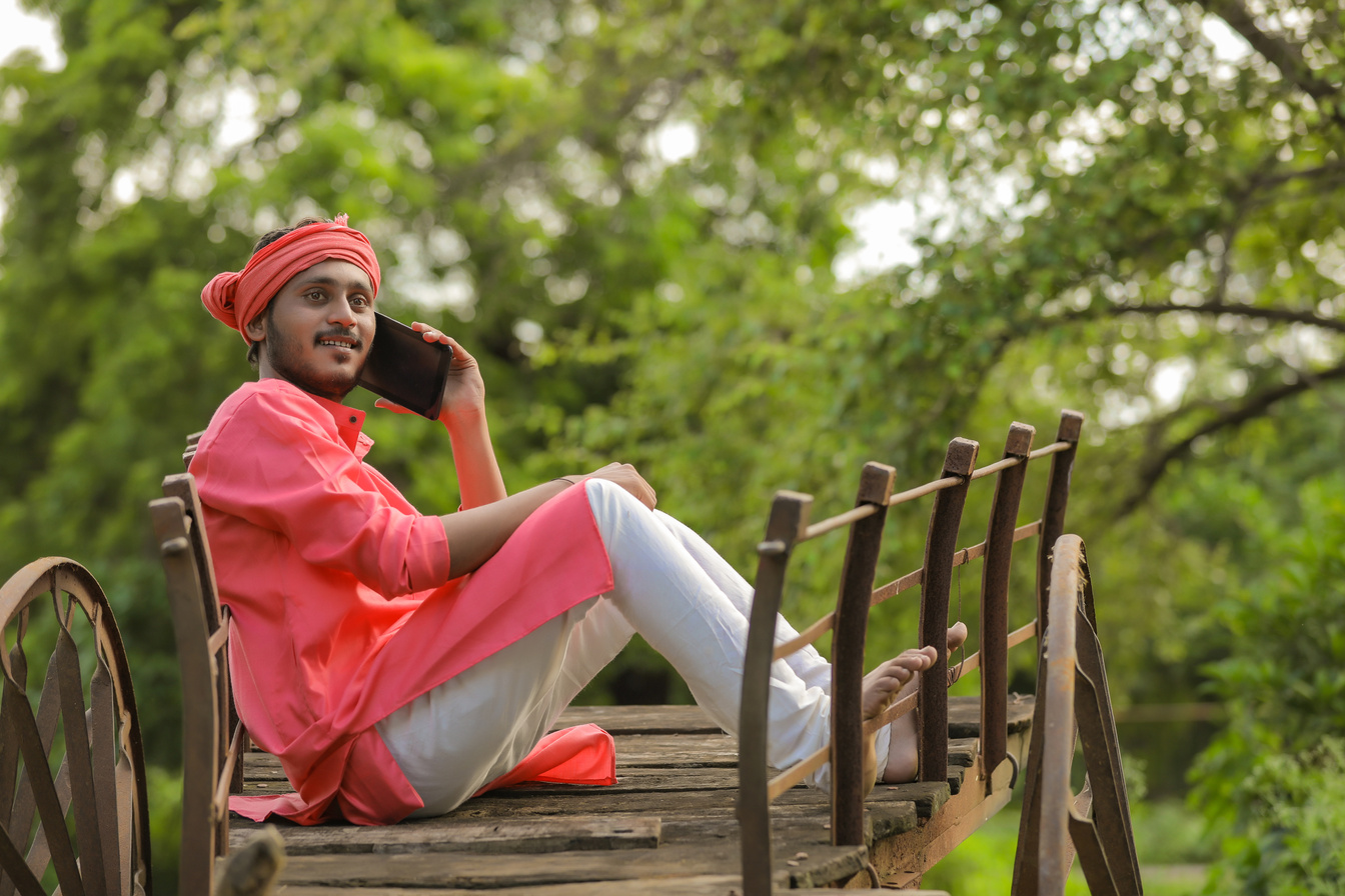 Young indian farmer talking on mobile phone