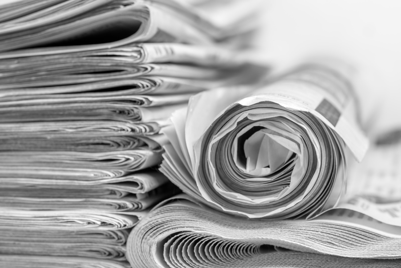 A stack of morning news newspapers, information from print media.